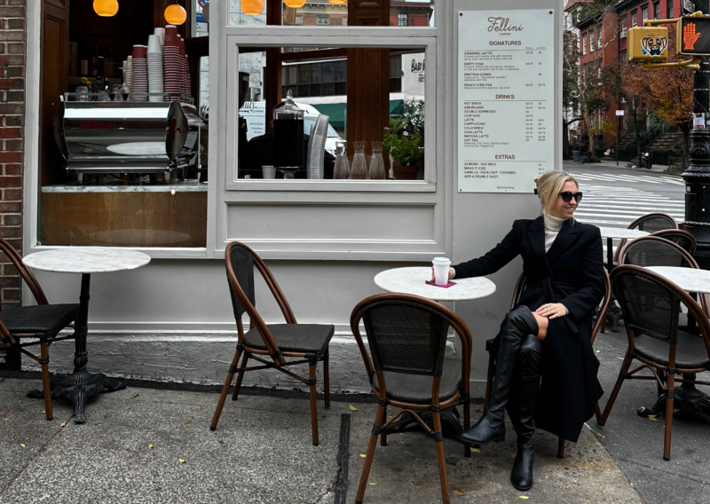 What to Pack for New York in Winter: 6 Packing Tips You Need Ally drinking coffee at fellini coffee in the west village nyc