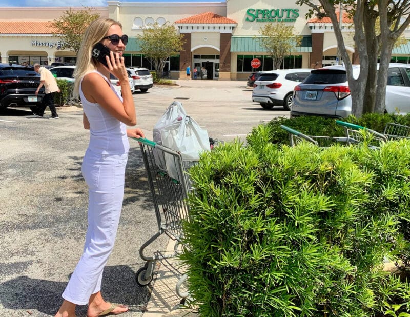 Ally shopping and talking on the phone with peak design phone case and grocieries