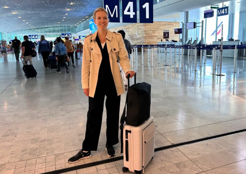 Ally traveling in paris at cog airport with the maverick co vista backpack and horizn studios m5 cabin luggage