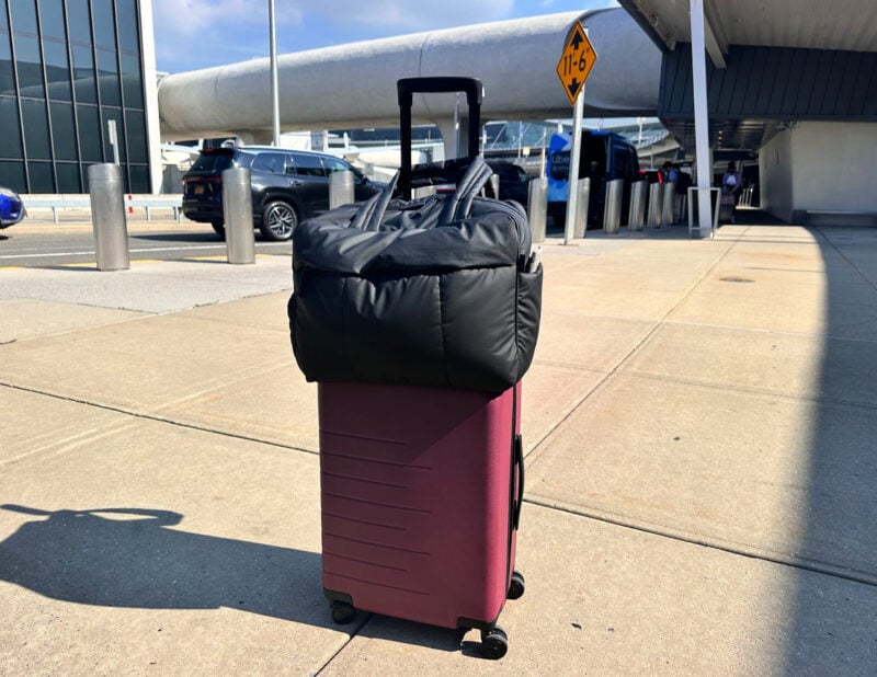 quince carry on and the calpak luka duffel at JFK in nyc summer 2026