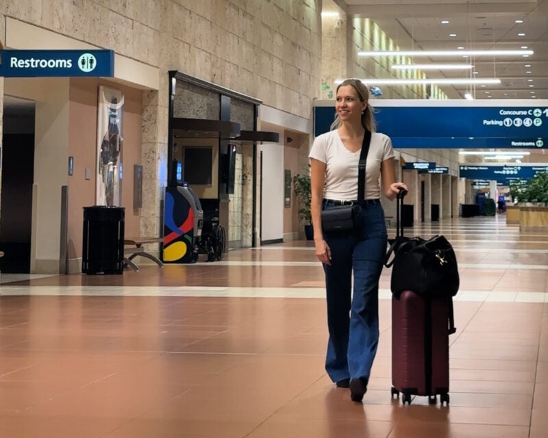 Quince Carry-On Review 2026: Worth It After 4 Real Trips? ally traveling with the quince carry-on quince leather weekender and bandolier crossbody pbi airport-7