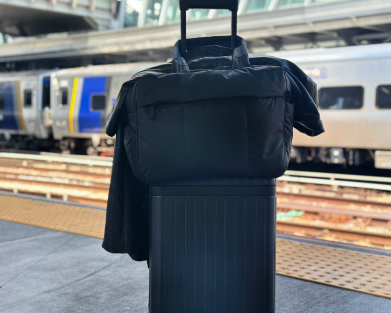 Carl Friedrik The Core Carry-On Review: Is It an Elite Bag? carl fredrik the core carry-on with the calk Luka duffel and a leather trench coat at jfk LIRR station