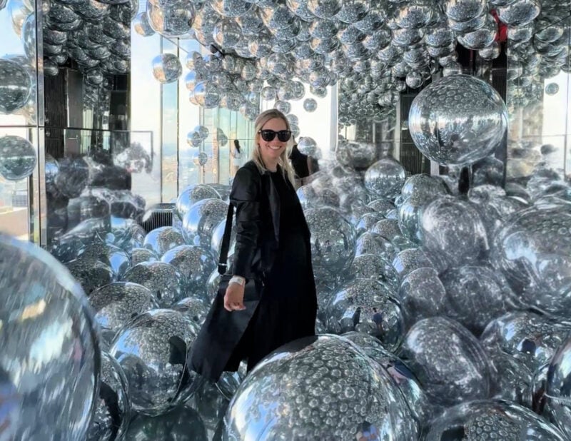 SUMMIT One Vanderbilt Review: Is the Immersive Deck Worth It? (2026) ALLY TRAVELS - SUMMIT One Vanderbilt Review_ Is the Immersive Deck Worth It? - Ally at Summit in the balloon room one Vanderbilt in NYC - June 2026