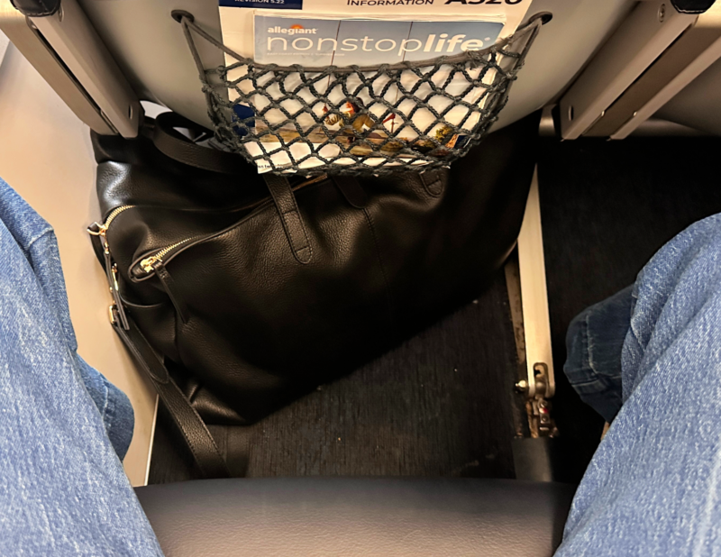 Quince Italian Leather Weekender Review: Worth It? quince italian leather weekender under the seat as a personal item on allegiant