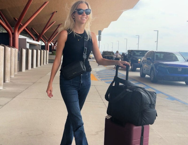 Quince Carry-On Review 2026: Worth It After 4 Real Trips? Ally at Pittsburgh Airport with the Quince Carry-On and the Calpak Luka Duffel and bandolier miller crossbody