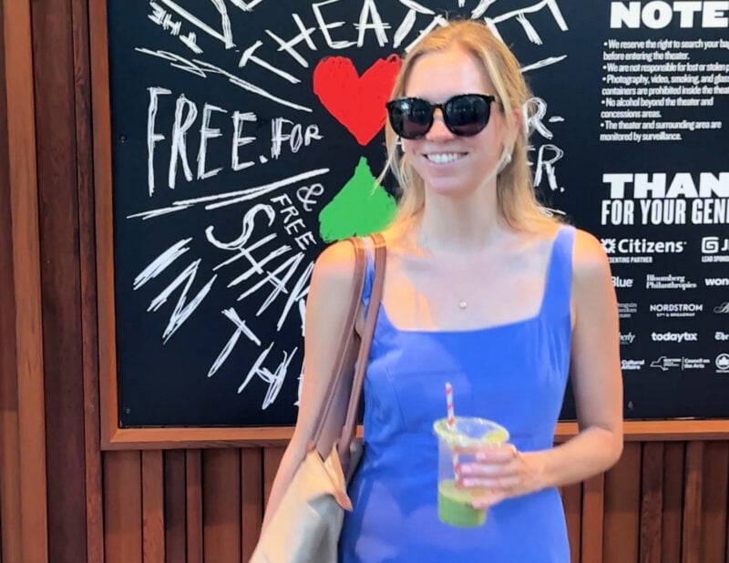 Shakespeare in the Park NYC: Your 2026 Guide to Free Theater ally with her matcha in front of the shakespeare in the park sign