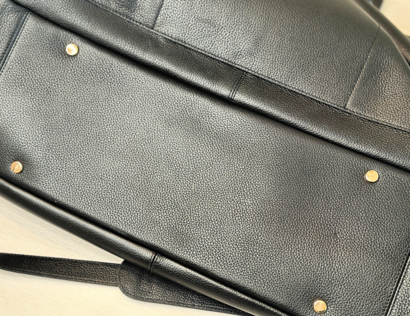 Quince Italian Leather Weekender Review: Worth It? feet on the bottom of the quince leather weekender
