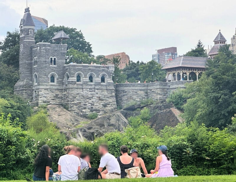 Shakespeare in the Park NYC: Your 2026 Guide to Free Theater people picnicking before Shakespeare in the park in front of belvedere castle