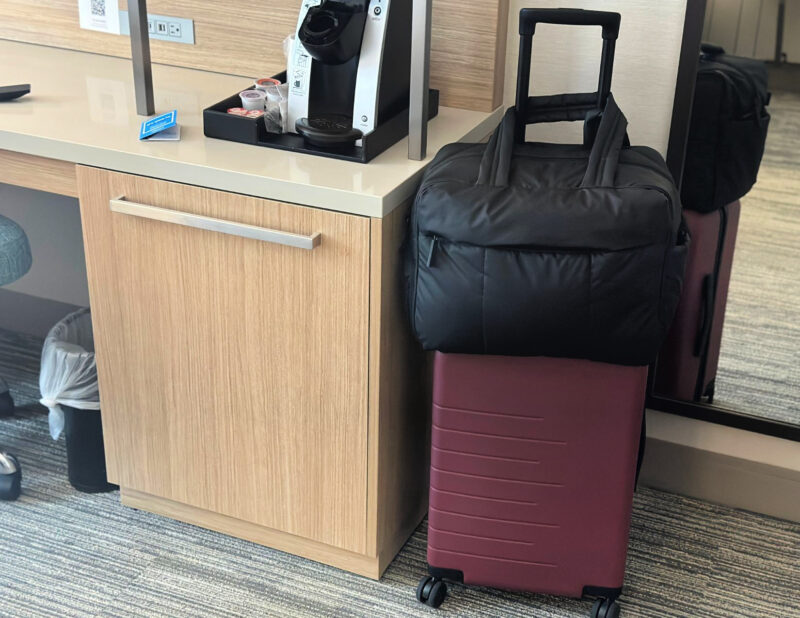 Quince Carry-On Review 2026: Worth It After 4 Real Trips? quince carry-on and luka duffel in the Hilton midtown east nyc - summer 2026